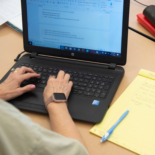 Individual Typing on Laptop