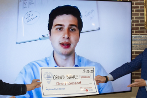 Big ideas winner Alejandro Villaquiran with his check virtually