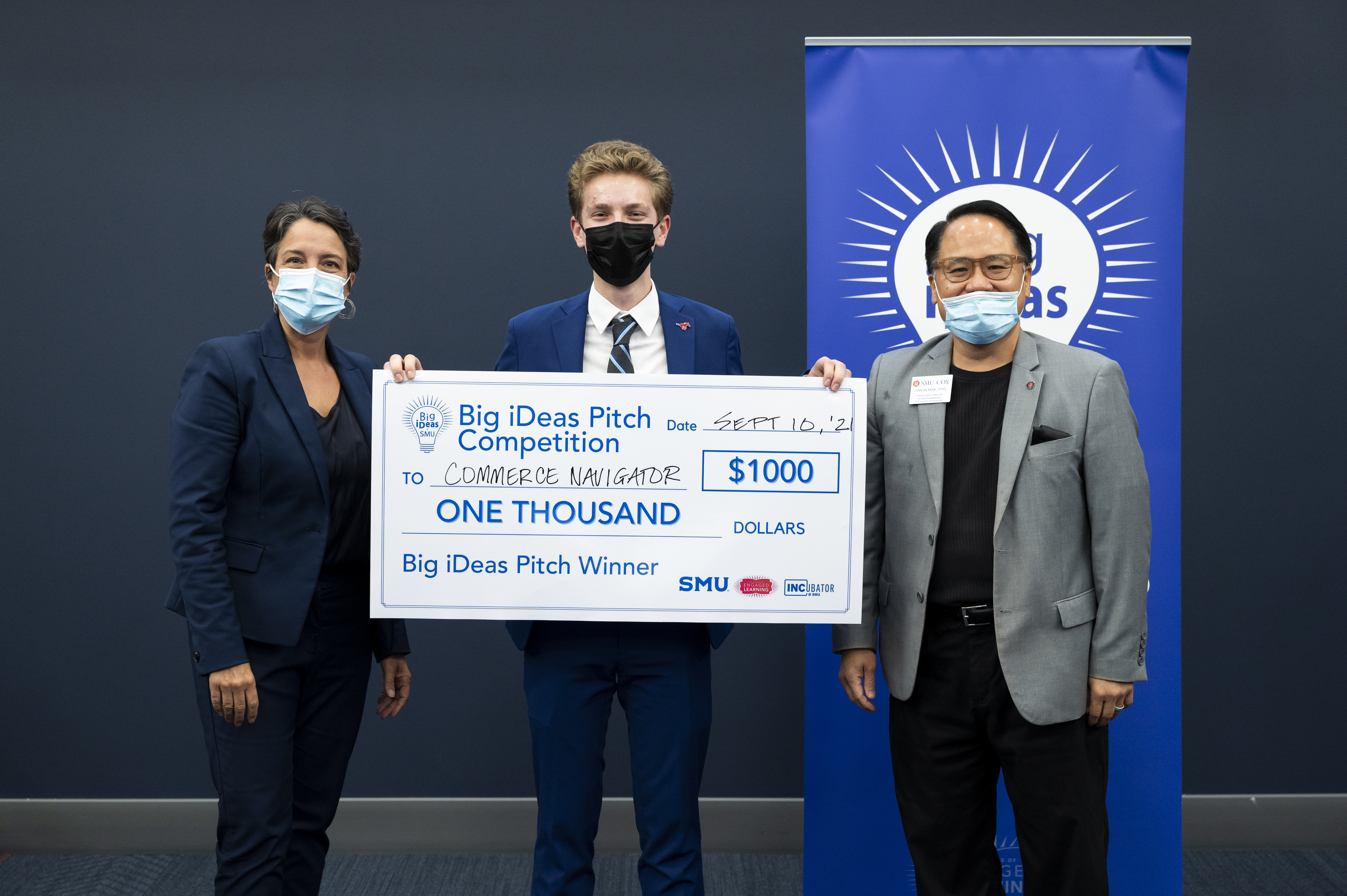 Picture of Jude Lugo (center) with his big check. Jennifer Ebinger (left) and Simon Mack (right)