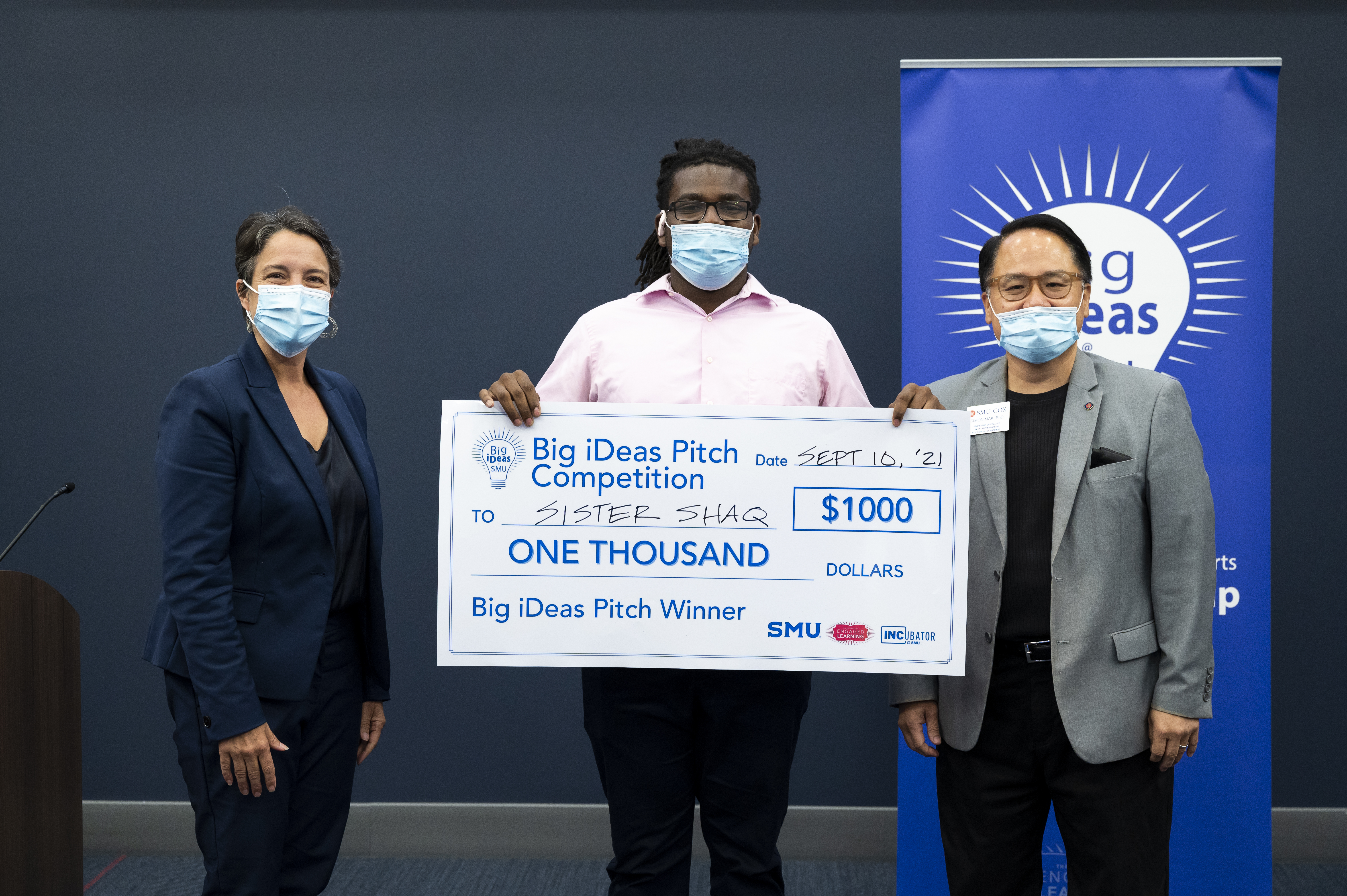 Picture of Keyshon Jones (center) with his big check. Jennifer Ebinger (left) and Simon Mak (right)