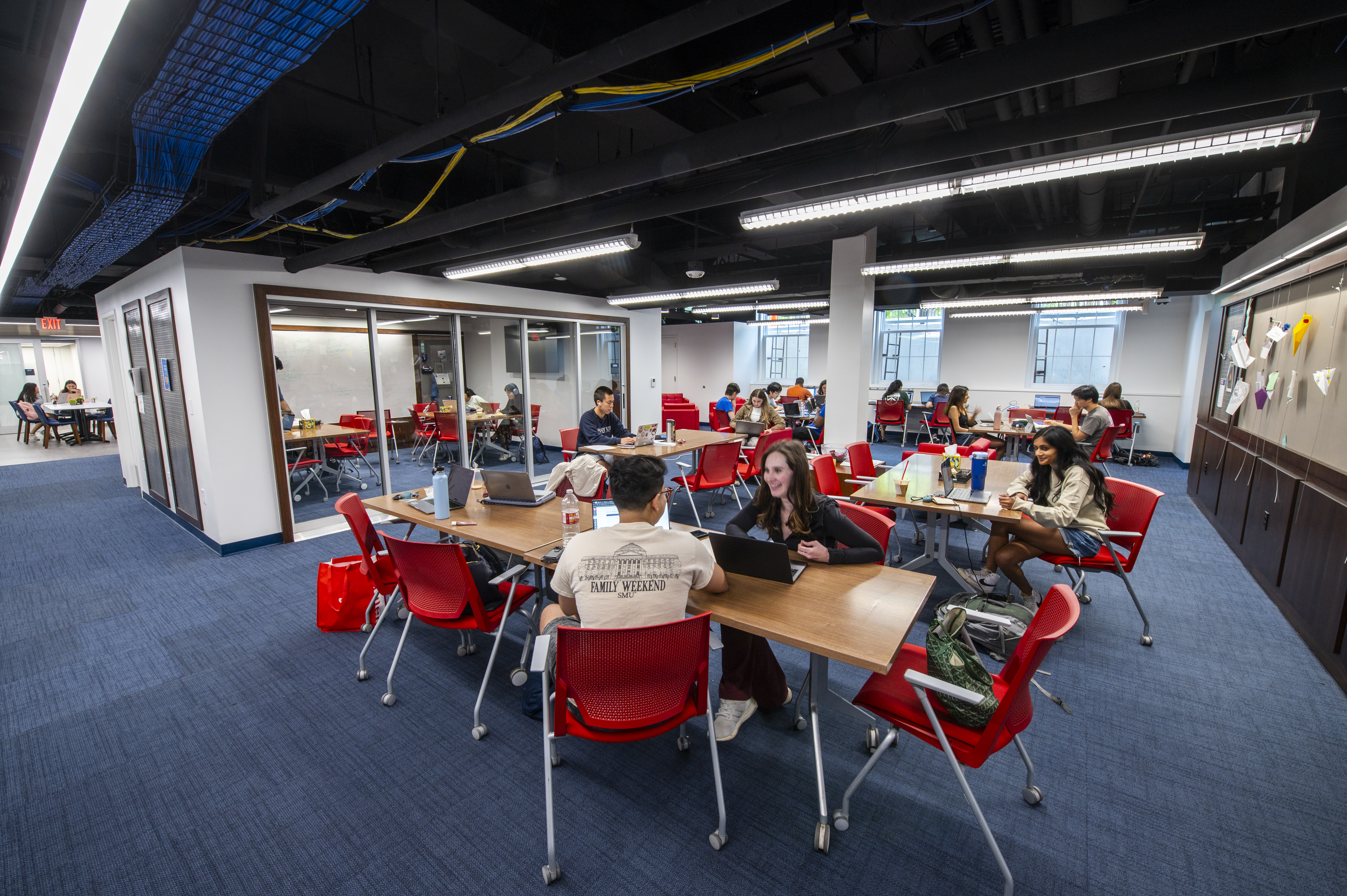 Wide angle shot of students studying in the scholars den