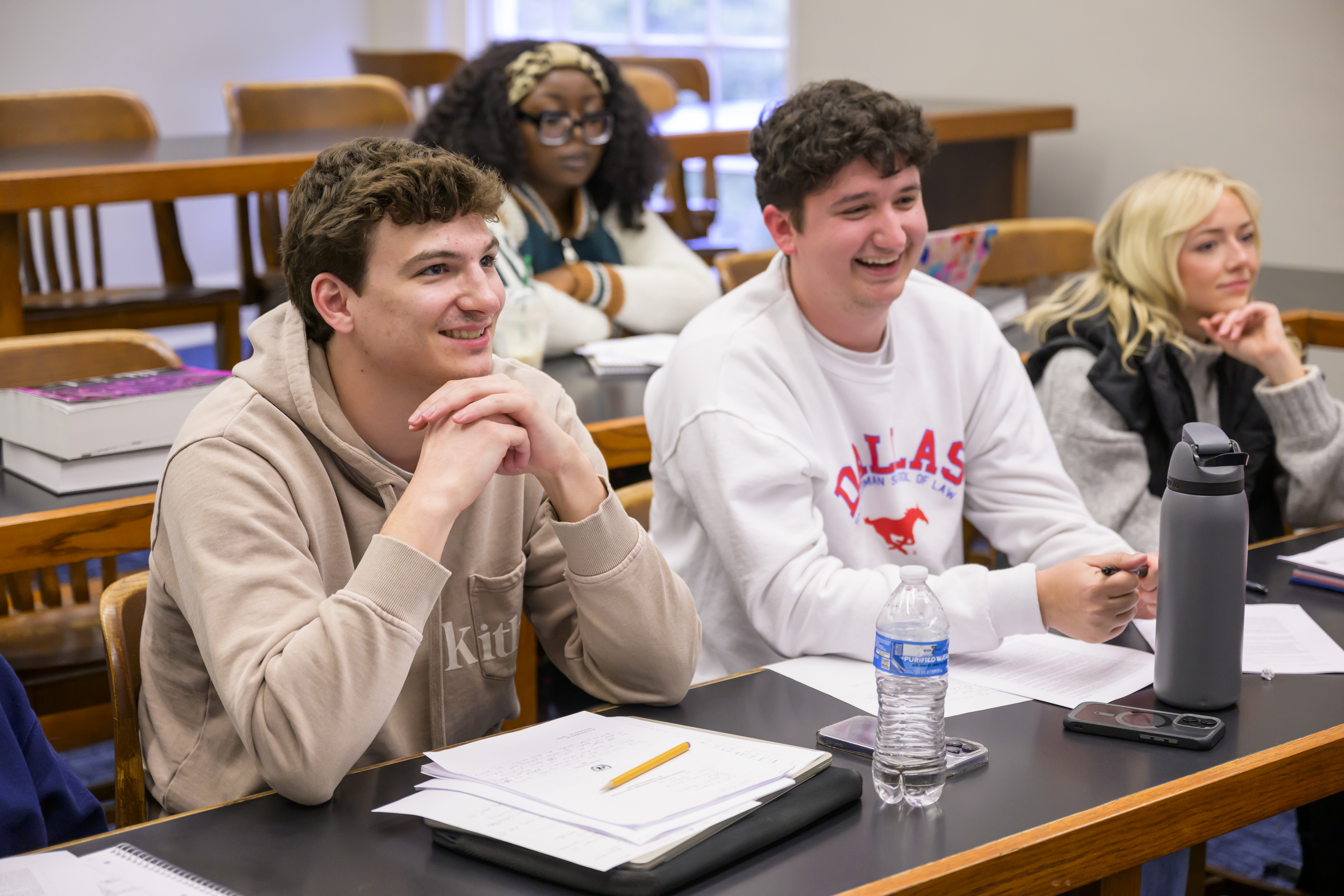 Four students sitting in classroom enjoying a seminar
