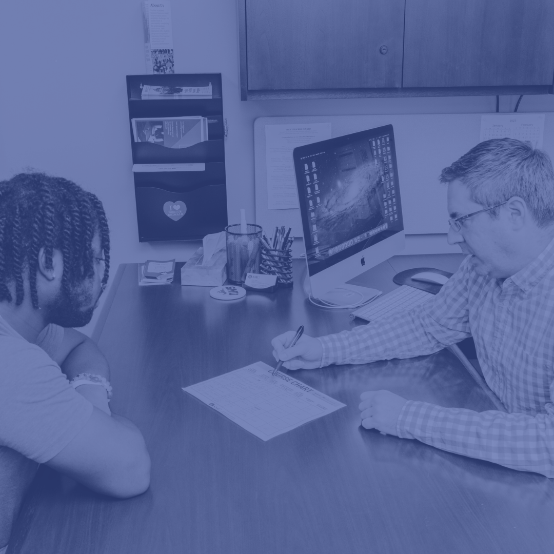 photo of student and academic advisor going over degree plan