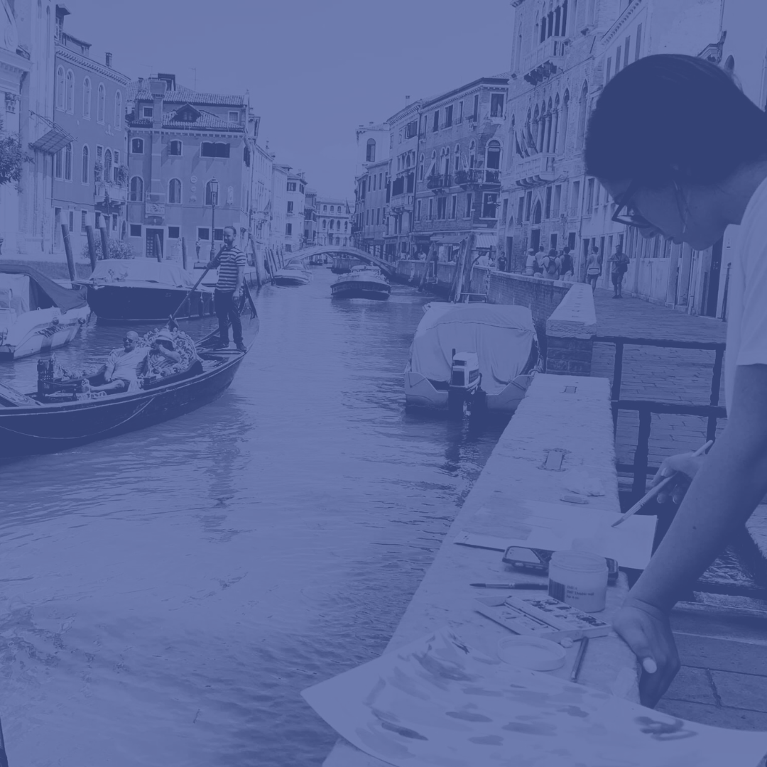 image of student sketching a picture next to a canal in Venice, Italy