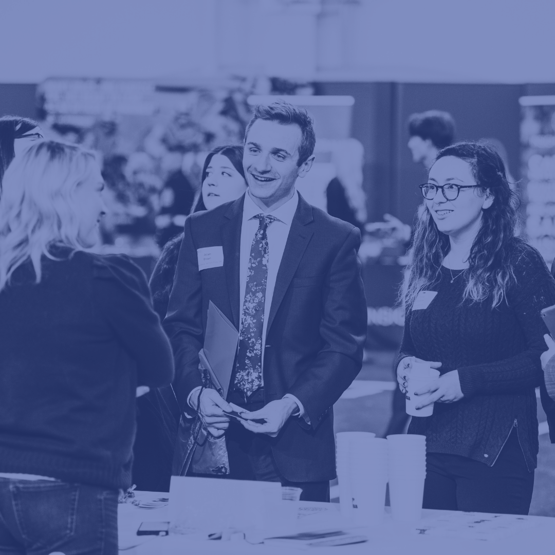 students talking to corporate recruiters at a career fair