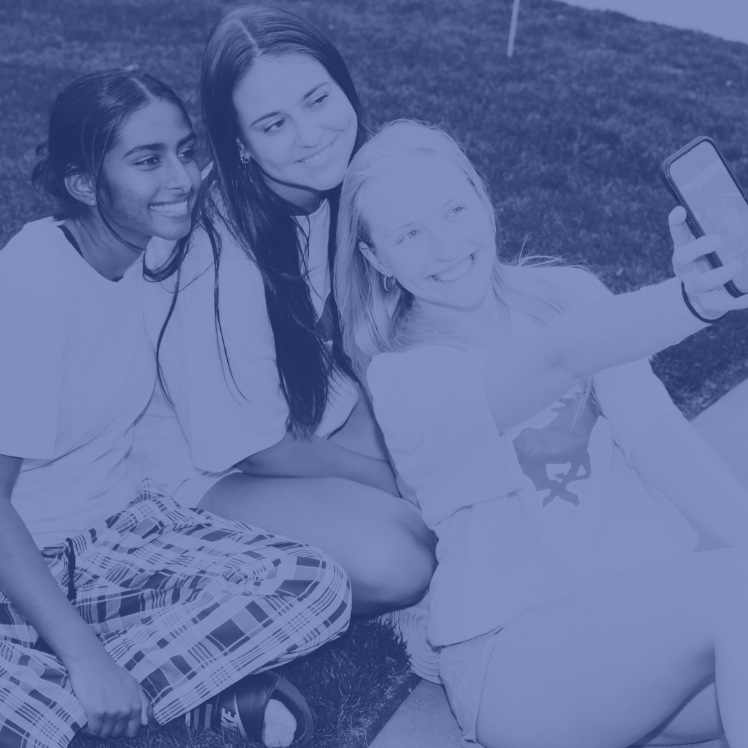 three SMU students taking a selfie with their phone