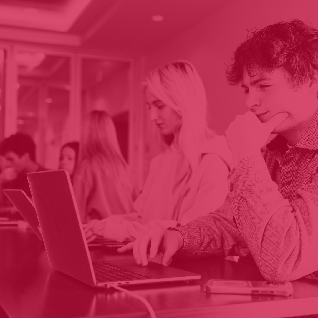 multiple students at their laptops and thinking hard