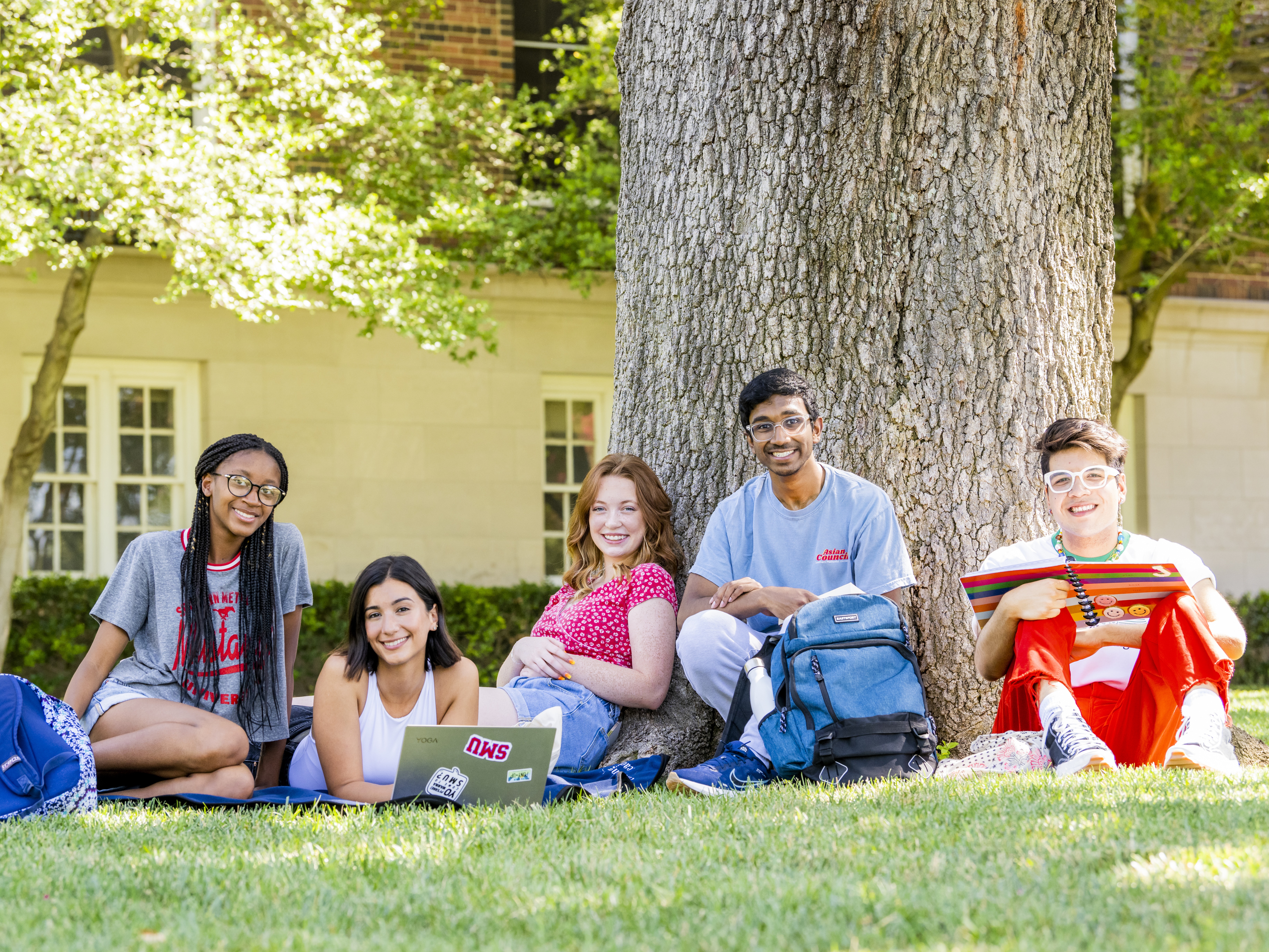 Students hanging out together on the lawn