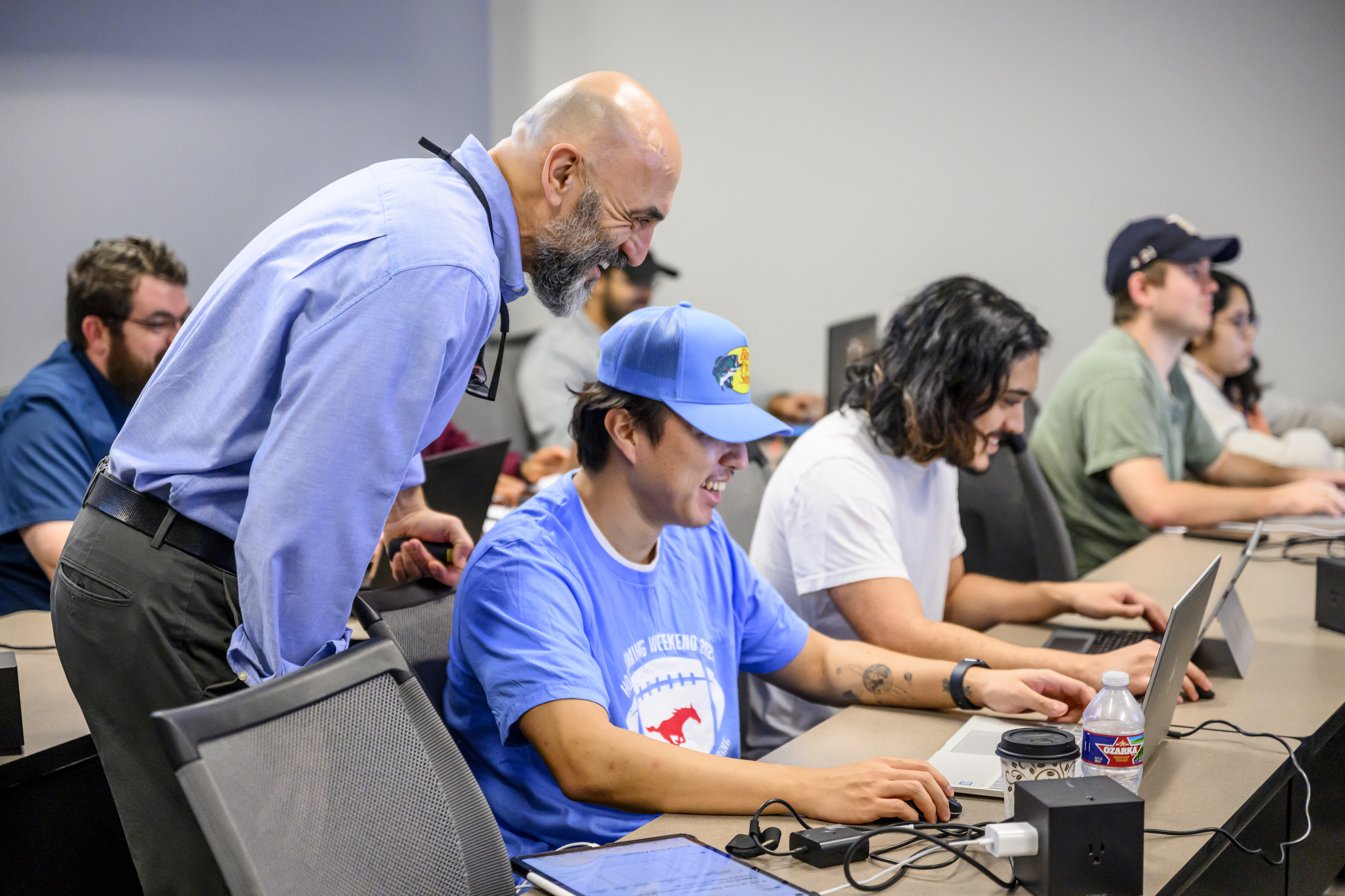 Professor looking over a student's laptop