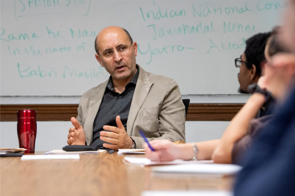 Faculty member sitting at table