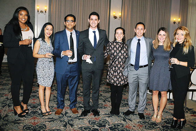 group of eight students standing in formal attire