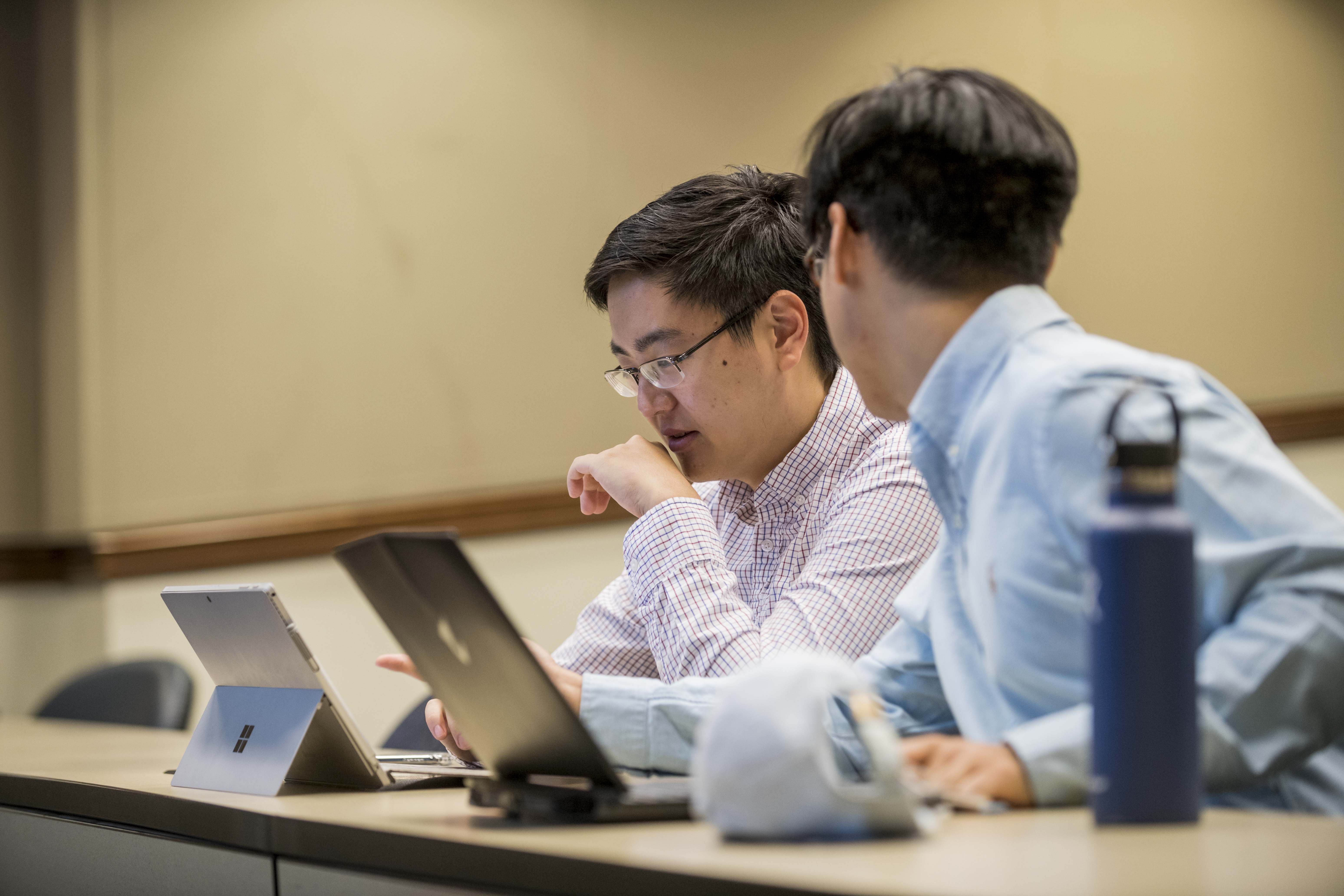 two students talking in class