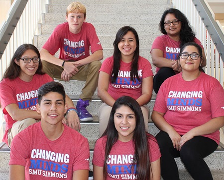 Highschool students site on stairs wearing Changing Minds SMU Simmons shirts