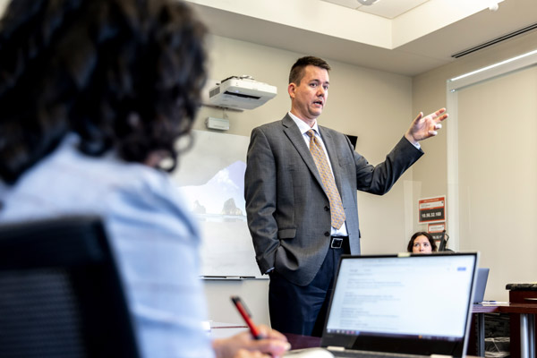 Dr. Michael Harris lectures in a classroom.