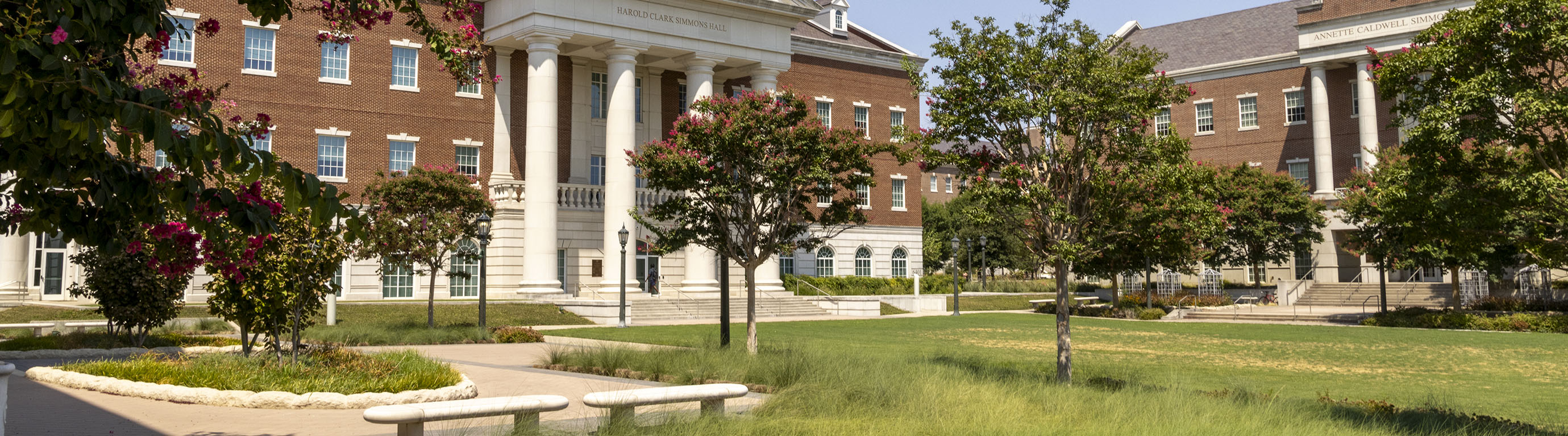 Landscaped courtyard at the SMU Simmons School of Education and Human Development, framed by Harold Clark Simmons Hall and Annette Caldwell Simmons Hall on the Southern Methodist University campus.