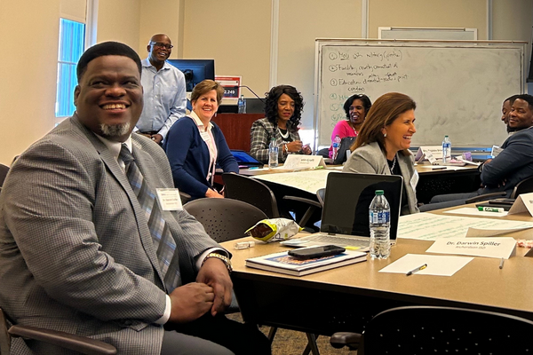 People sitting at tables and smiling