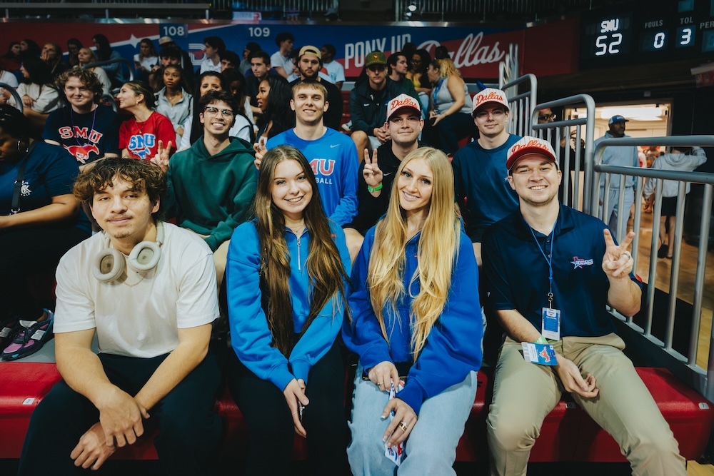 Students in SMU’s sport management program at SMU interact during a home basketball game.