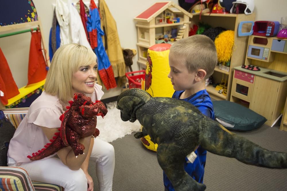 A Master of Science in Counseling student engages with a child in the SMU Center for Family Counseling play therapy room.
