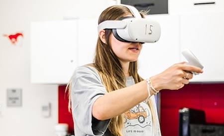 A research participant holding a Quest II controller.