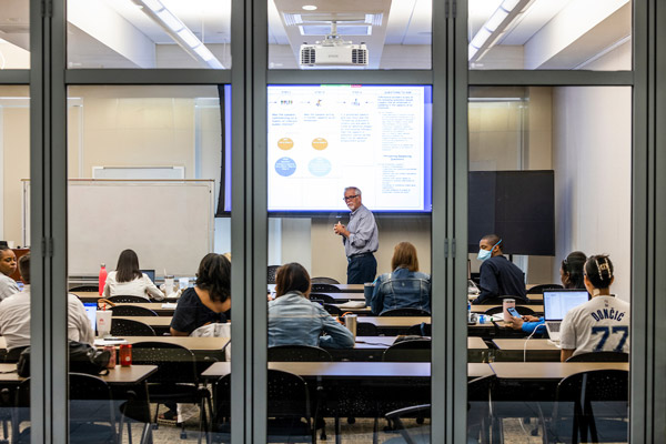 Dr. Watt Lesley Black delivers a presentation to a group of educators