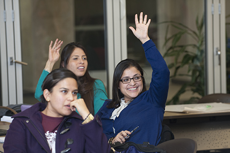 Simmons students raising hand in class