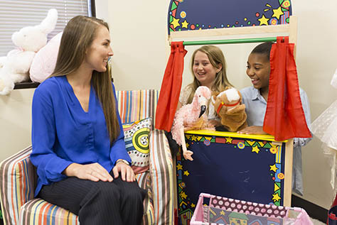 Simmons Counseling teacher talking to grade school students