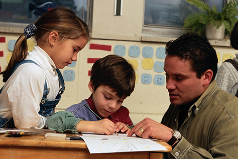 Simmons teacher working with grade school students
