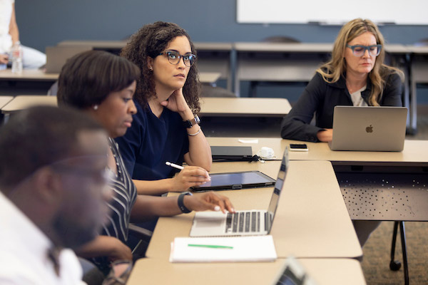 Group of educators at desks in a classroom, participating in a leadership program for Pre-K-to-12.