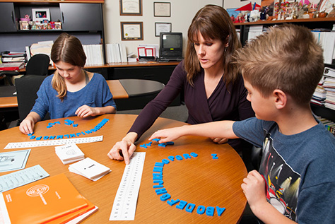 Simmons teacher working with middle school students
