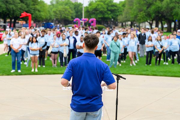 MEd Leader in front of crowd.