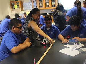 Upward Bound Math Science Projects instructor with students in lab