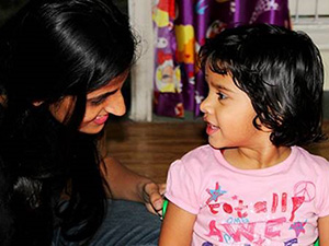 Child and teacher in classroom environment.