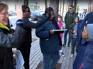 Giving high five to group of people in a moment of shared excitement and camaraderie at the Dallas Arboretum