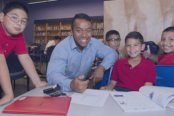 Teacher with group of students in middle-school classroom