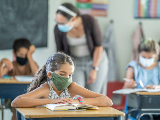 Students reading books for education in school classroom