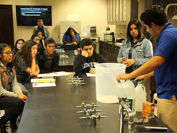 Students in school chemistry labratory learning about properties of gases.