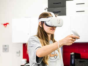 A research participant holding a Quest II controller.