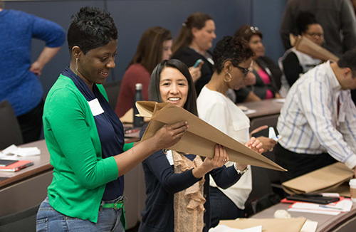 Conference participants working on STEM project during presentation