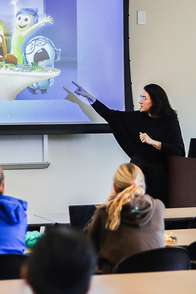 A classroom of students watches a presentation.