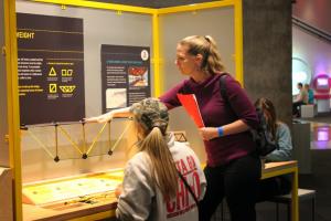 STEM instructor explaining engineering model to student