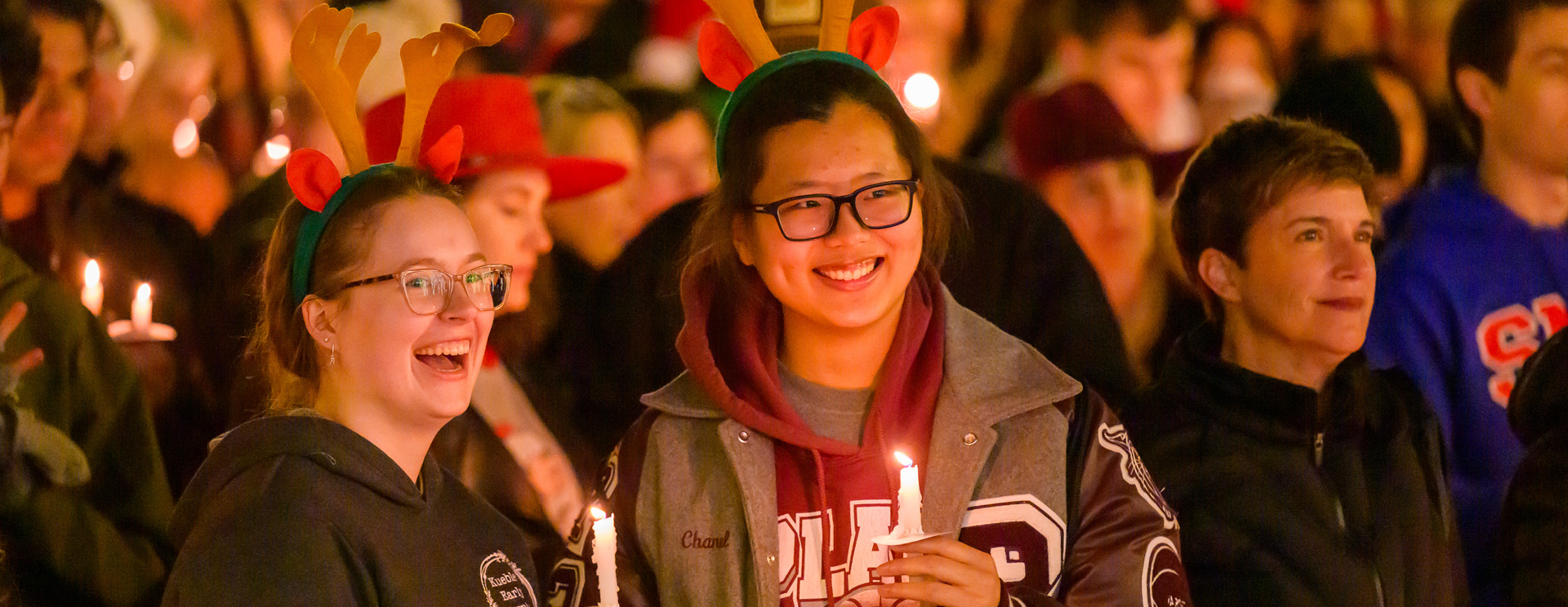 Students with lit candles at the Celebration of lights