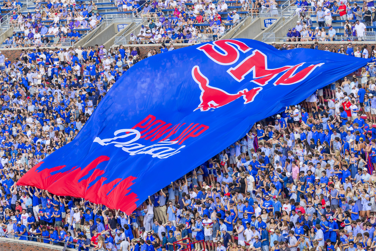 Students at a home game with a large SMU banner