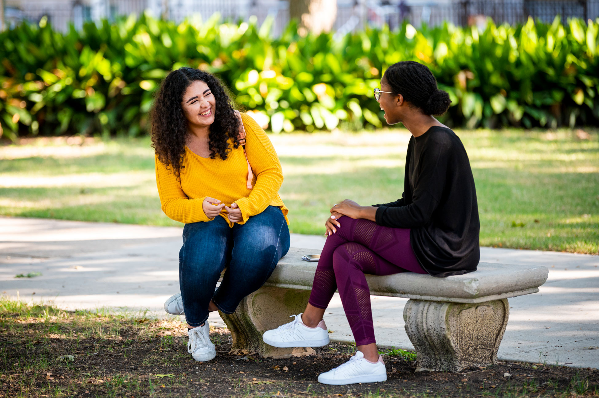 girls talking on bench