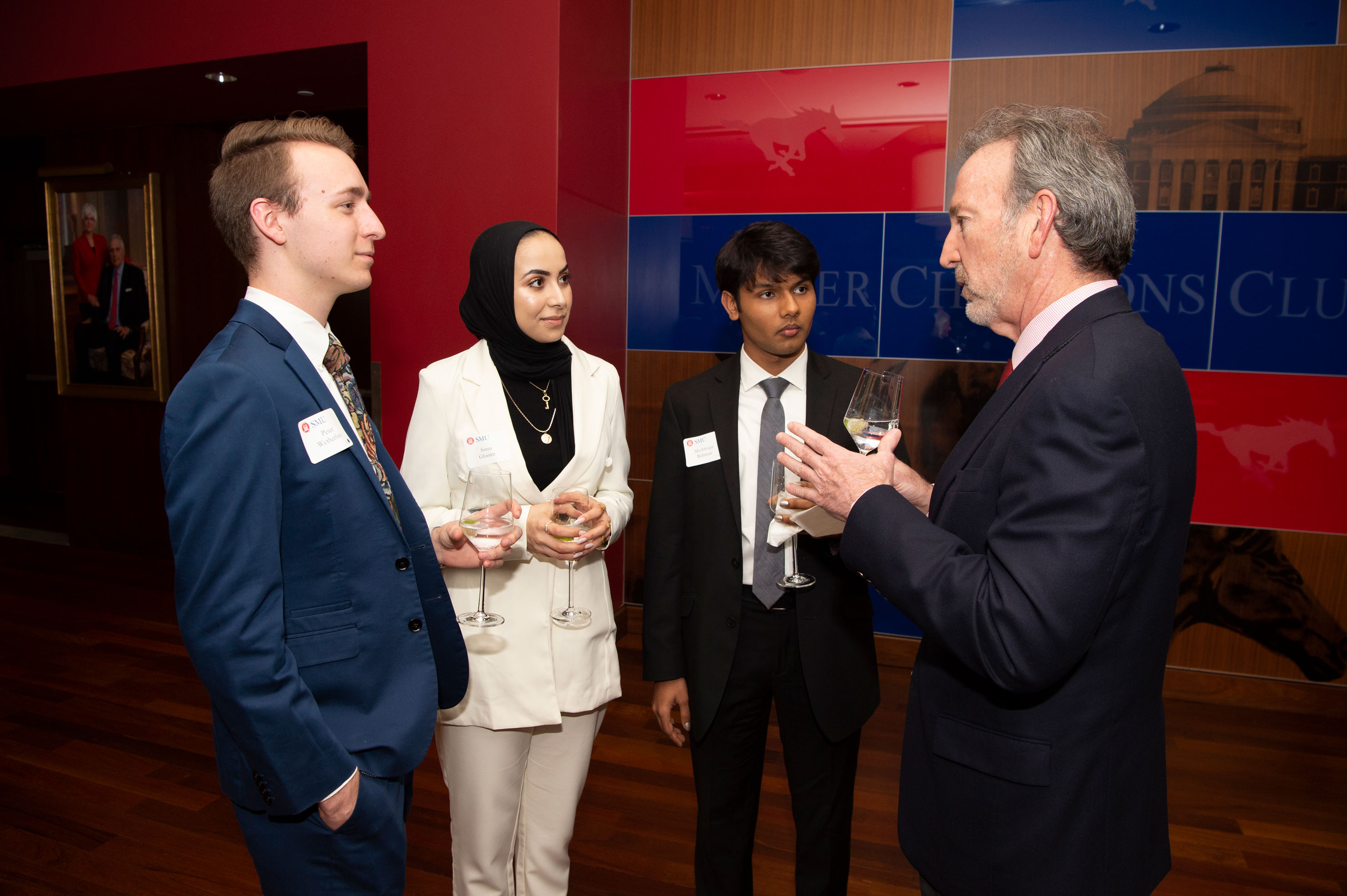 students talking with board of trustees member