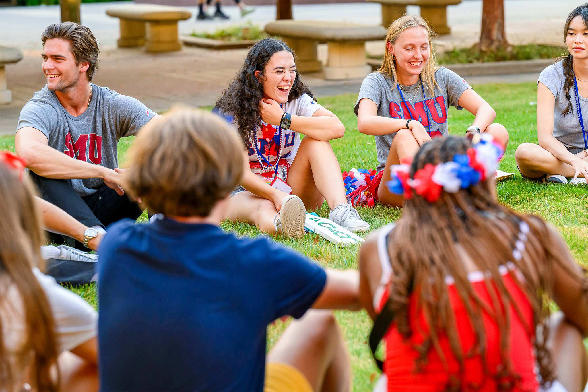 Students sitting outside in a circle having fun during Stampede Kick-off