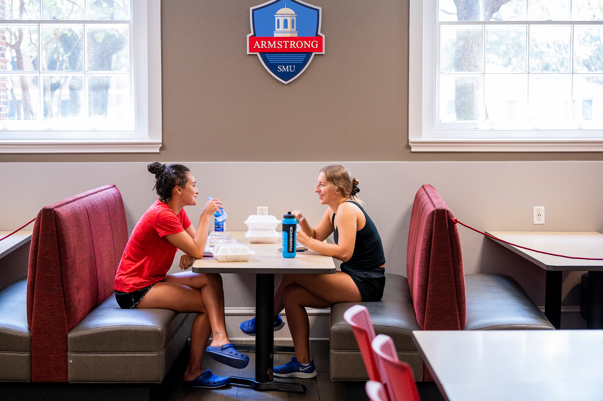 two students sitting at table in a dinning hall