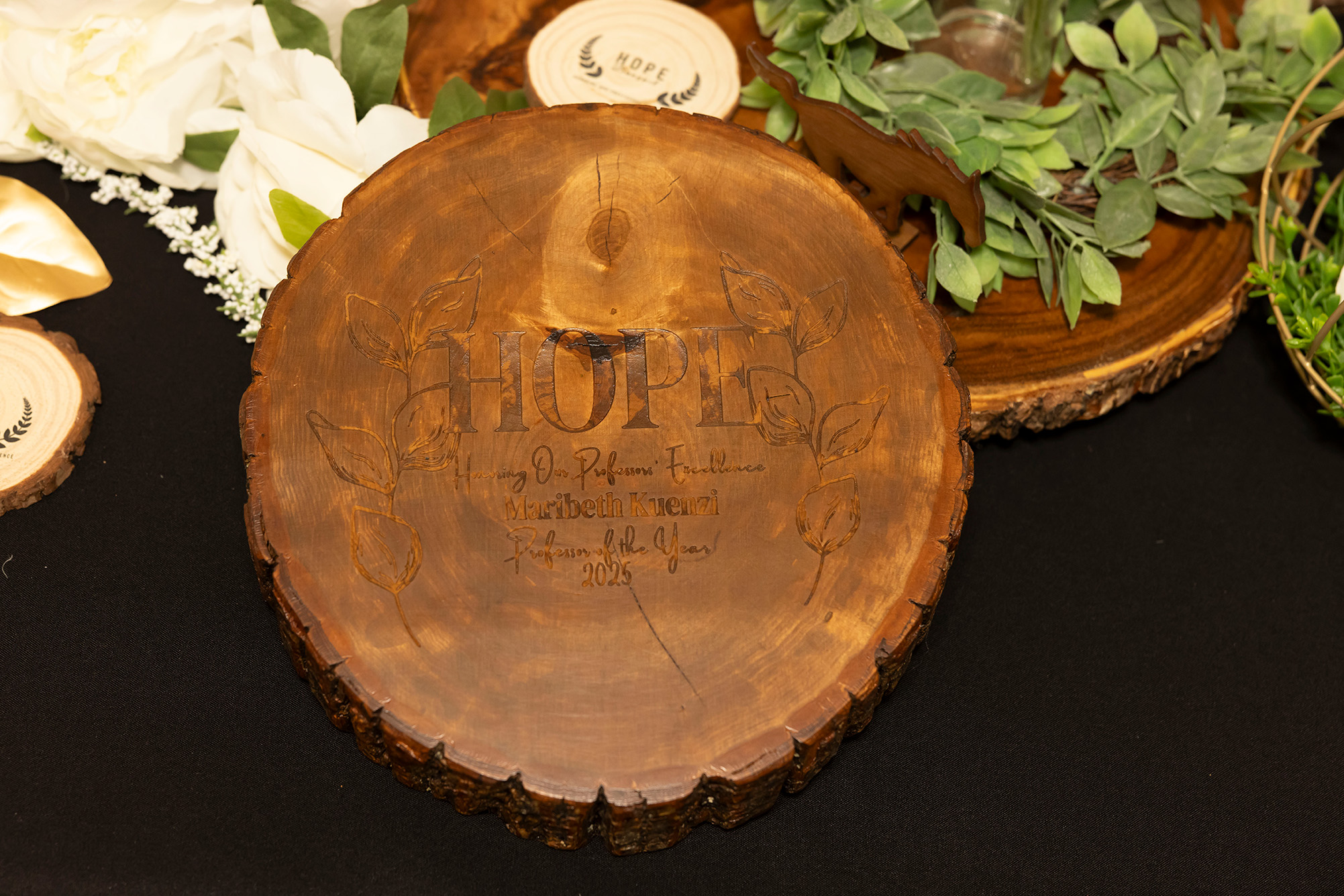 engraved wood for award on black tablecloth