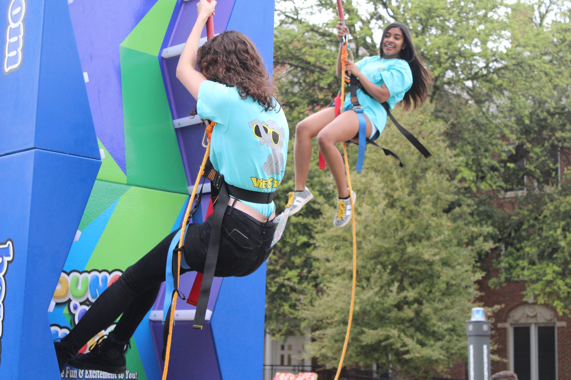 VieSta Students riding climbing wall in the courtyard.