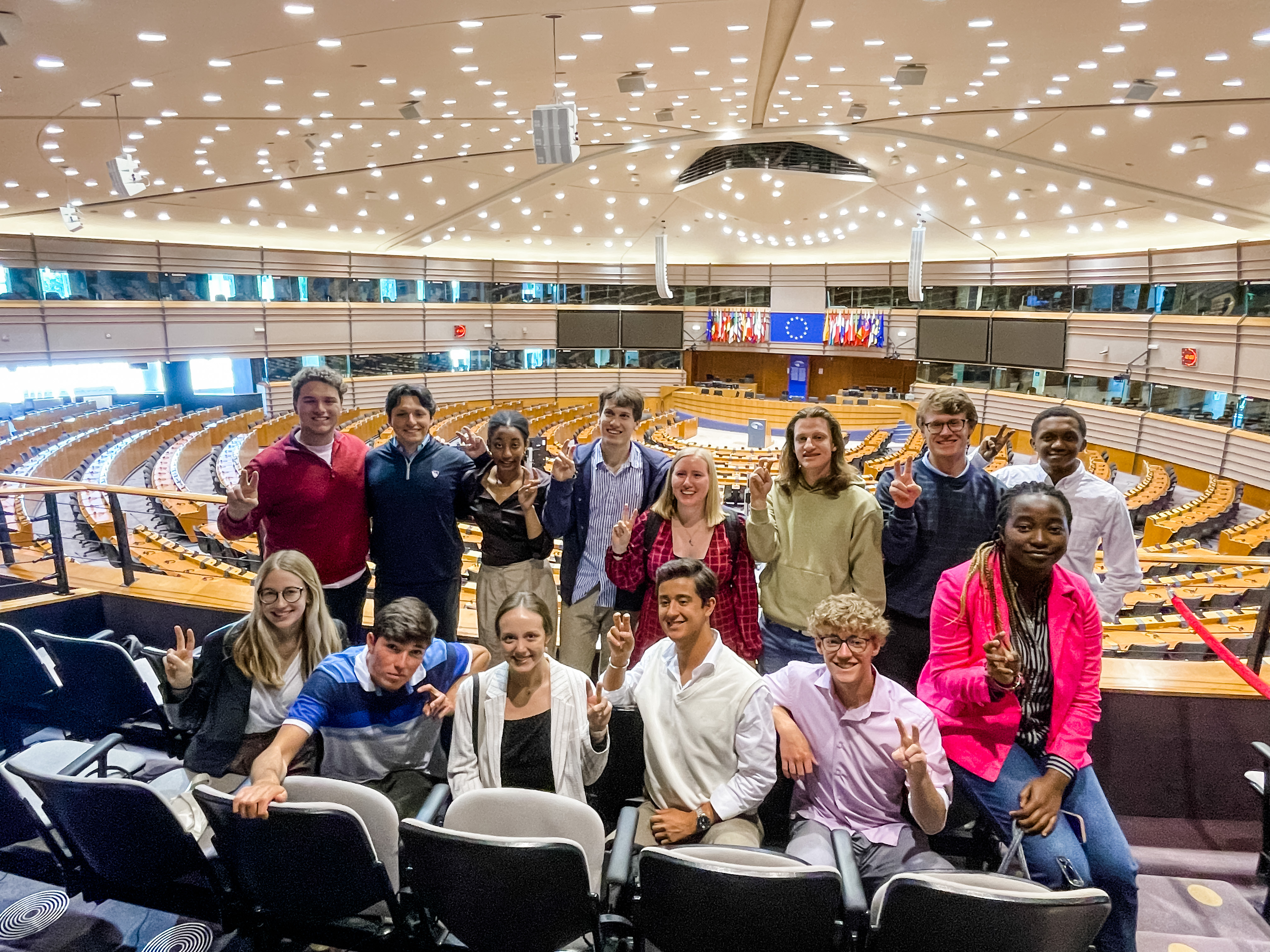 students in auditorium smiling and posing for photo