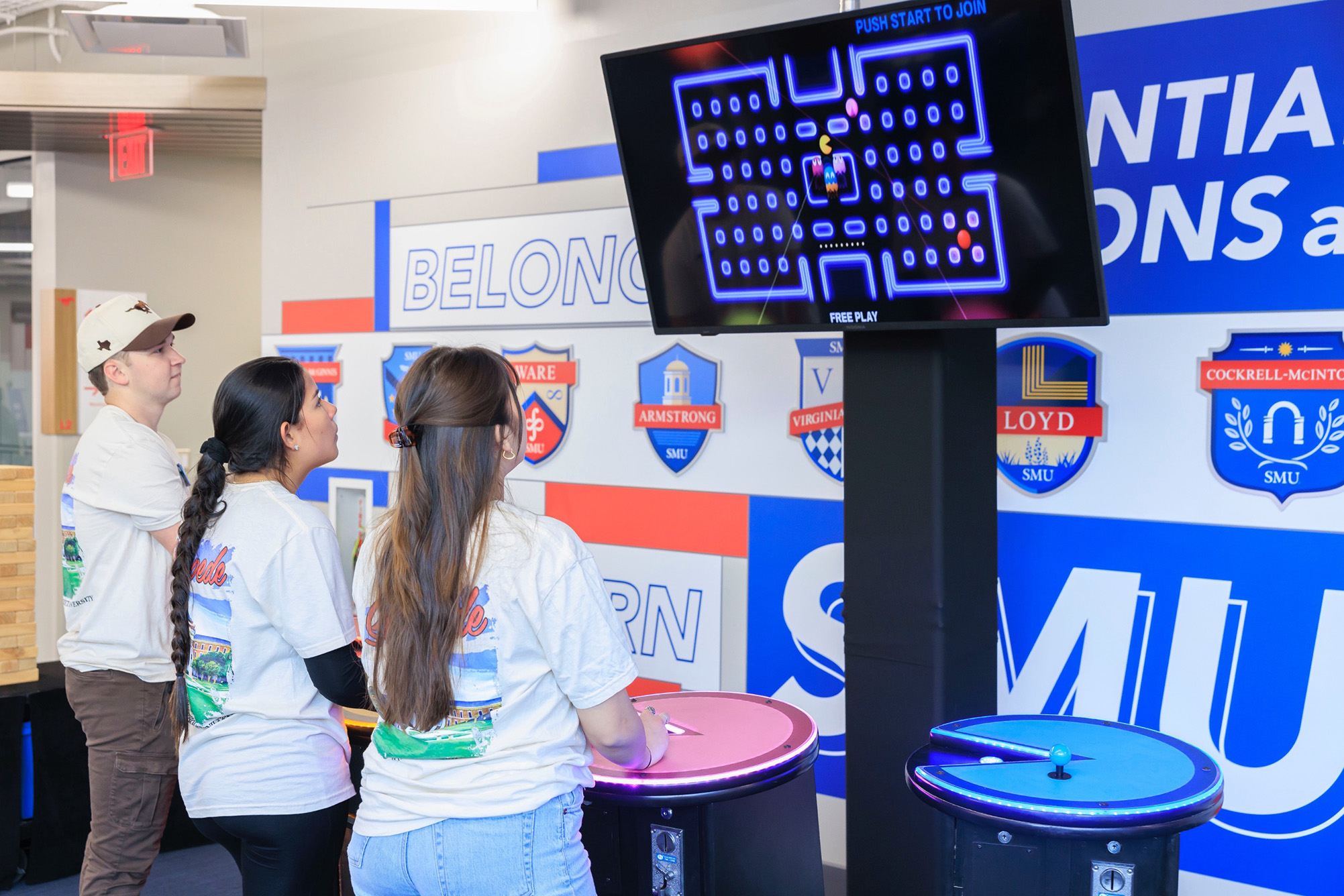 three students playing a video game